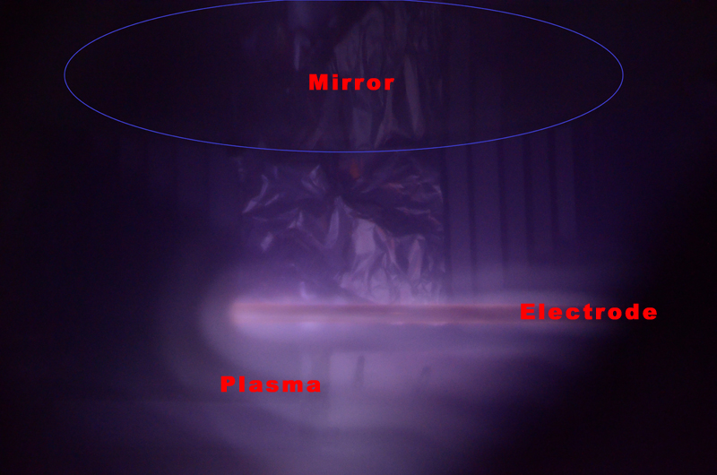 Glow discharge plasma cleaning inside the vacuum chamber, with mirror and electrode positions labeled